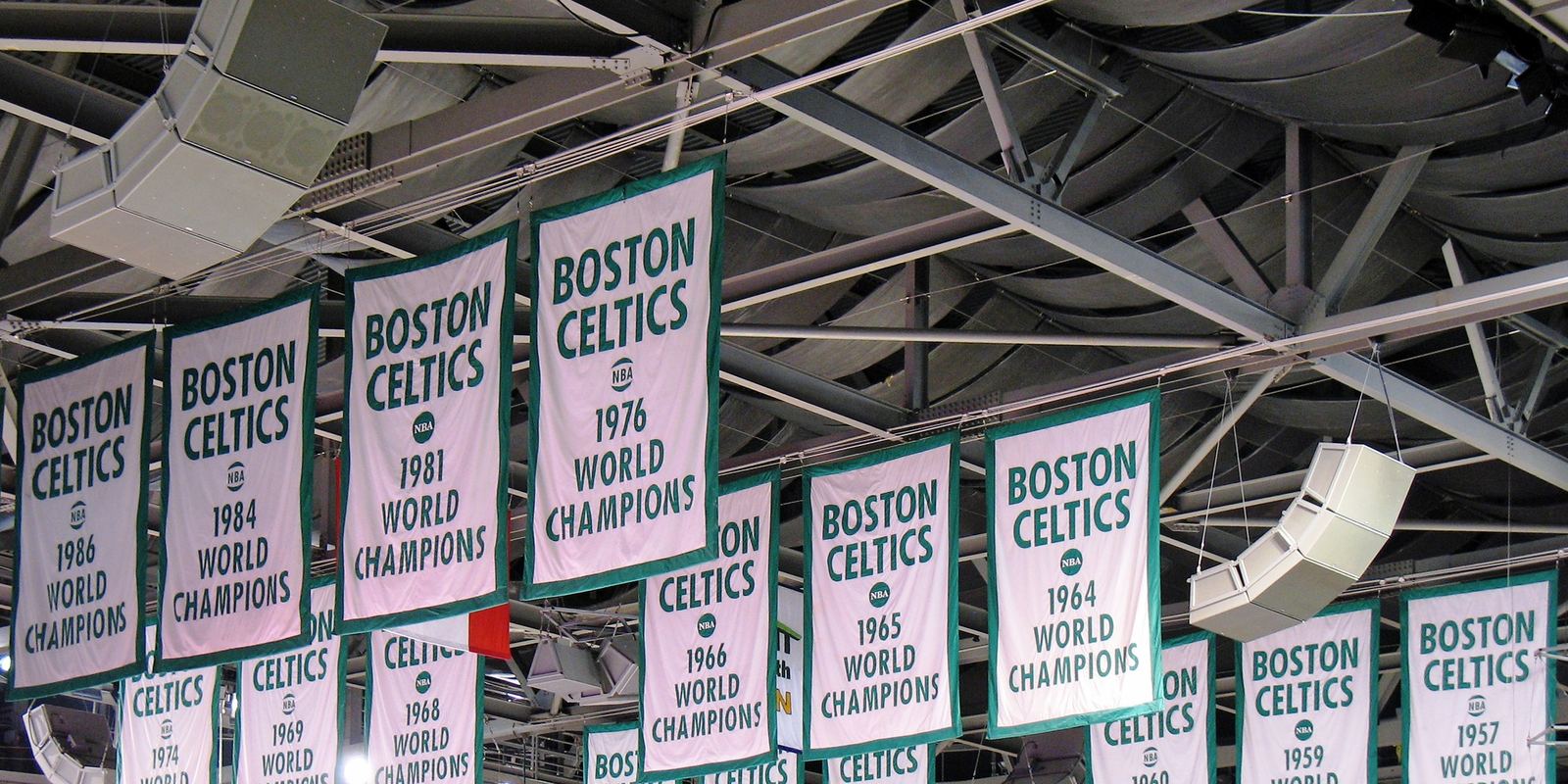 Green and white Boston Celtics championship banners hanging in the arena rafters