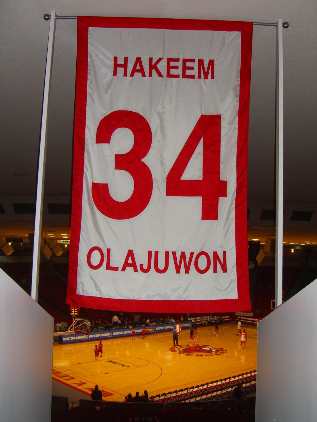A red and white banner for Hakeem Olajuwon's retired number 34 at the University of Houston
