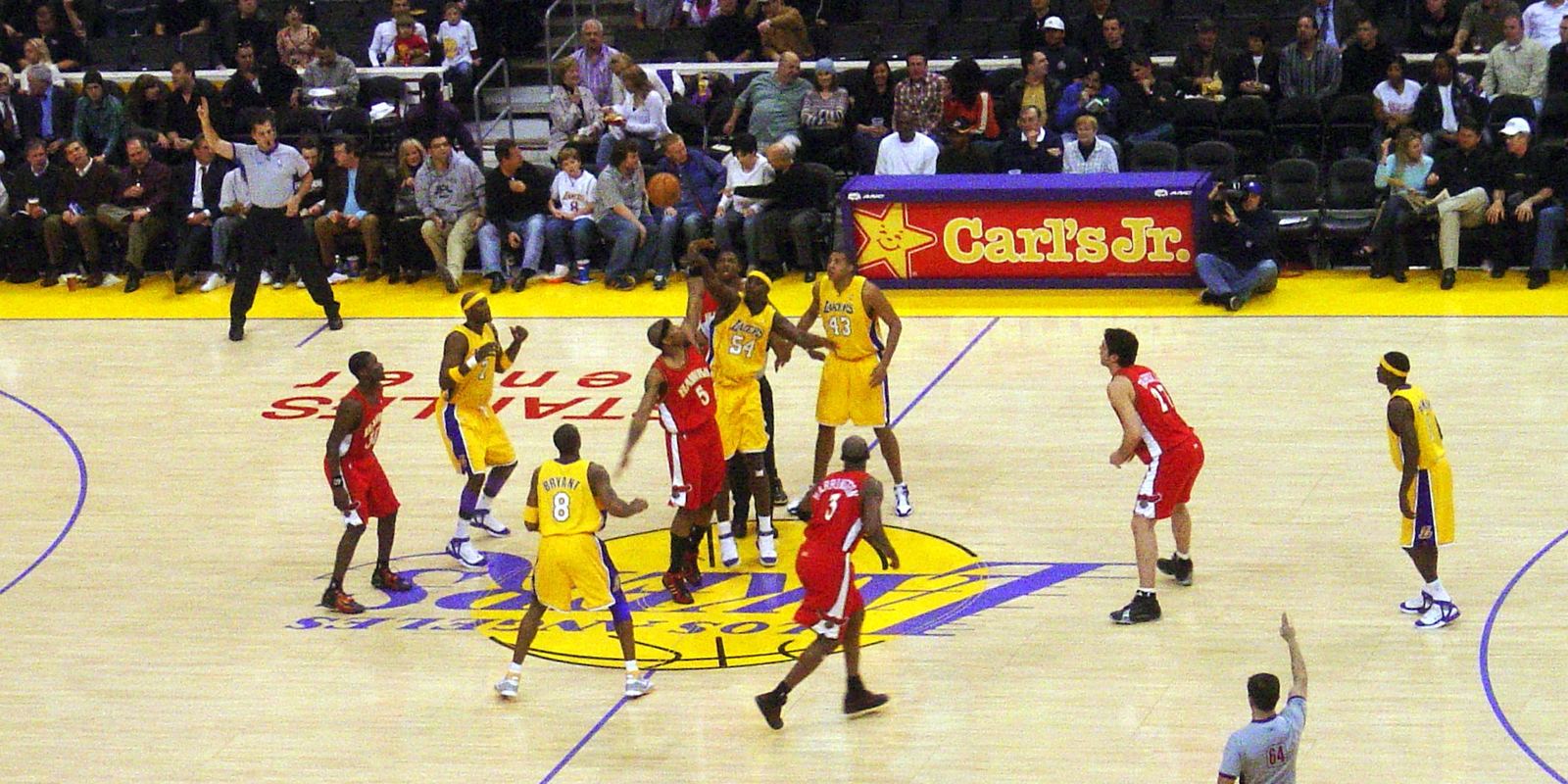 A Lakers home game in Los Angeles with players spread across the gold court
