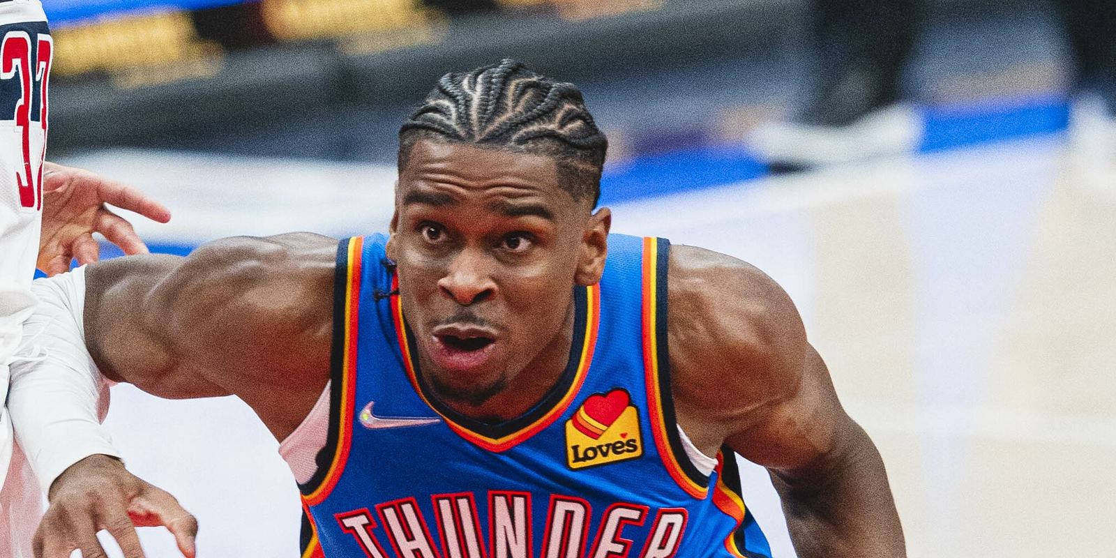 Shai Gilgeous-Alexander in a blue Oklahoma City Thunder jersey with the ball